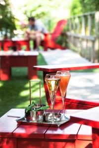 two champagne glasses on a tray on a table at La Mare aux Oiseaux, The Originals Collection (Relais du Silence) in Saint-Joachim