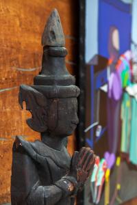 a statue of a little boy standing next to a building at La Mare aux Oiseaux, The Originals Collection (Relais du Silence) in Saint-Joachim