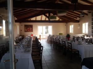 a large room with tables and chairs with white tablecloths at Casa Selene Rocchi in Savignano sul Panaro