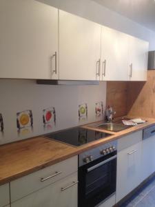 a kitchen with white cabinets and a sink at Haus Schnurbus in Olsberg