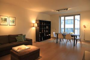 a living room with a couch and a table at NEW Design apartment in Brussels in Brussels