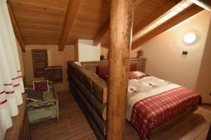 a bedroom with a wooden bed in a room at Tobià Gries in Canazei