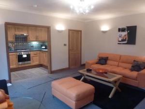 a living room with a couch and a table at Hewlett Apartments in Cheltenham