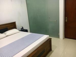 Postel nebo postele na pokoji v ubytování Kandy Citylights Residence