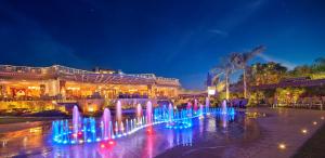 a fountain in front of a building at night at Al Masa Hotel Nasr City in Cairo