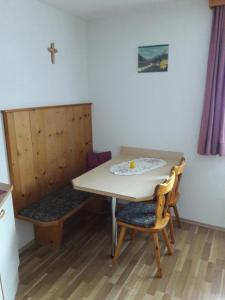 a small room with a table and two chairs at Ferienwohnung Wolf in Trins