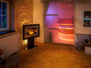 a living room with a fireplace with a view of the ocean at G&auml;stezimmer Im Haus Am Wald in Freudenstadt
