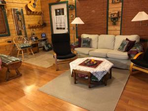 a living room with a couch and a table at The Gingerbread Cabin in Jasper