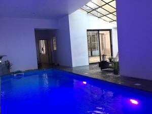 a large swimming pool with blue lighting in a house at Le 3 fuscien in Amiens