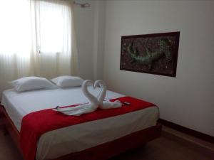 Postel nebo postele na pokoji v ubytování Hostal El Pinzón