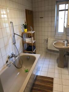 a bathroom with a bath tub and a sink at Ferienwohnung Perlitz in Petersdorf