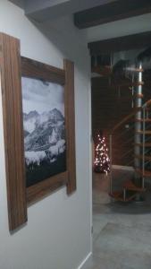 a picture of a mountain on a wall in a room at Apartament Palisander in Kościelisko