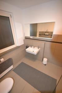 a bathroom with a sink and a mirror at Madame Tower in Cologne +45 photos