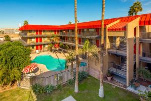 an aerial view of a hotel with a pool and palm trees at Travelers Inn - Phoenix in Phoenix