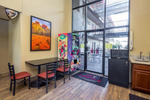a kitchen and dining room with a table and a refrigerator at Travelers Inn - Phoenix in Phoenix