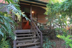 a wooden cabin with stairs leading to the front door at Maleny Hotel in Maleny