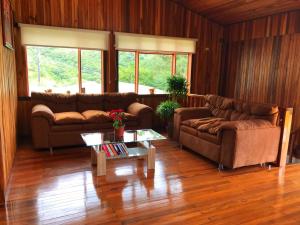 a living room with two couches and a coffee table at Mar Inn Costa Rica in Monteverde Costa Rica