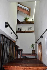 a stairway with a wooden bench and a skylight at Apartmán Sarah Noemi, 100 m SKIBUS JASNA in Liptovský Mikuláš