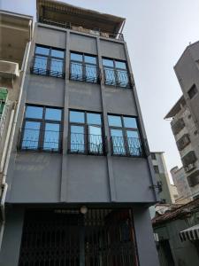 a tall building with windows on the side of it at OYAJI Guesthouse 歐野基民家宿泊 in Tainan
