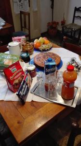 a wooden table with food and condiments on it at B&B La Dogana in Forlì