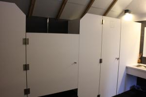 two white lockers in a room with a sink at B&B Pipowagen "het Wellnesst" op Wellness Camping en B&B Stoltenborg in Winterswijk-Meddo