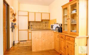 a kitchen with wooden cabinets and a counter top at Apartment Lakeside in Turracher Hohe