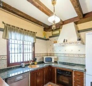 a kitchen with a sink and a counter top at Casa rural Huerta San Miguel 2010 in El Bosque