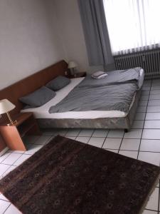 a bedroom with a bed and a rug on the floor at Lipmann am boll in Hamm