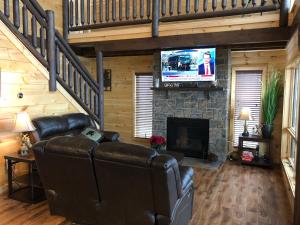 a living room with a couch and a fireplace at A View from the Top in Sevierville