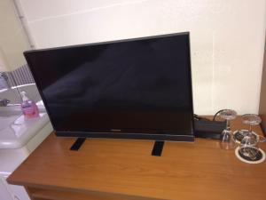 a flat screen tv sitting on top of a wooden table at Lipmann am boll in Hamm +13 photos