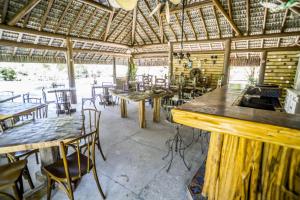 a room with tables and chairs in a restaurant at Pousada Udexere Eco House in Santo André