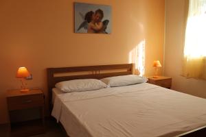 Postel nebo postele na pokoji v ubytování Residence Jonico