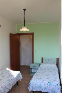 Postel nebo postele na pokoji v ubytování Residence Jonico