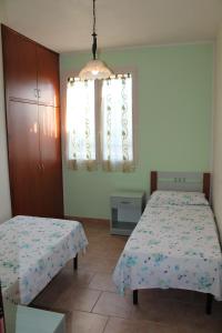Postel nebo postele na pokoji v ubytování Residence Jonico