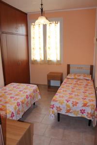 Postel nebo postele na pokoji v ubytování Residence Jonico