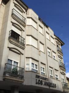 a tall building with a sign on the side of it at Hotel Los Angeles in La Ba&ntilde;eza