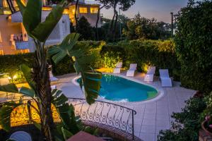 a swimming pool in the middle of a garden at VILLA MARYLU' in Ischia Town +18 photos