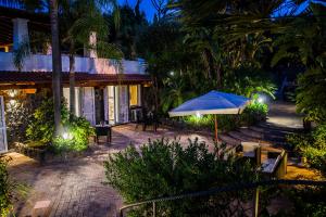 an umbrella in front of a house at night at VILLA MARYLU' in Ischia Town