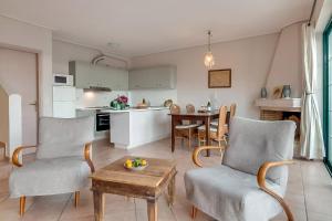 a kitchen and living room with a table and chairs at Villa Apostolata in Skala Kefalonias