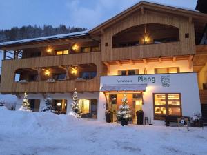 a building in the snow with a sign on it at Plang Farmhouse in San Cassiano