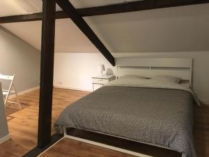 a bedroom with a large bed and a table at Hollandia City House in Hasselt