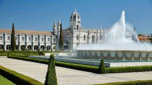 a large building with a fountain in front of a building at Belém 147 Apartment in Lisbon