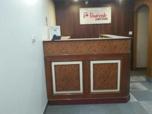 a lobby with a reception counter in a building at Pamposh Guest House GK II Market in New Delhi