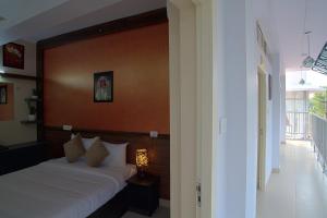 a bedroom with a bed with a wooden head board at Gems 9 Airport Hotel in Nedumbassery