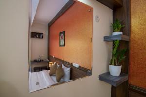 a mirror on the wall of a hotel room at Gems 9 Airport Hotel in Nedumbassery