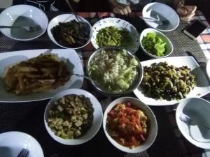a table with many plates of food on it at Hotel Camorich in Tissamaharama