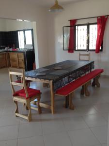 a ping pong table with a bench and a chair at La Somonoise in Somone