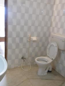 a bathroom with a toilet and a sink at Momotaro House in Bodh Gaya