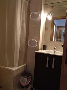 a bathroom with a sink and a mirror and a tub at Madrid Rent 4 in Madrid