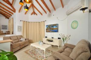 ein Wohnzimmer mit 2 Sofas und einem Tisch in der Unterkunft Family Villa in Safed